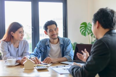 Couple discussing finances with their financial adviser