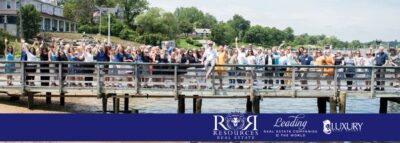 group of people on a pier stretching into the river