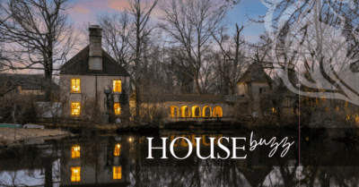 Gothic style home overlooking pond with the words "House Buzz" superimposed