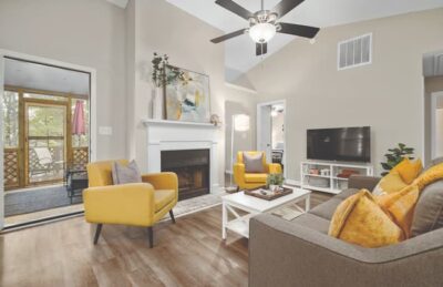 attractively decorated living room with fireplace and ceiling fan