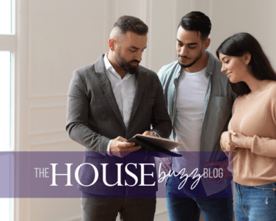 Realtor showing listing information to couple.