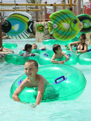 children in inner tubes floating at a waterpark