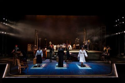 theater stage with performers on it in dramatic lighting