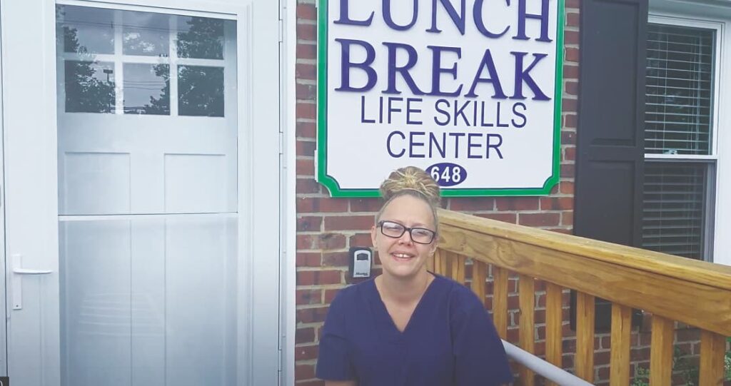 young woman sitting on porch at Life Skills center