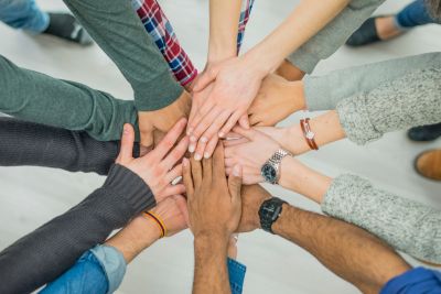 High Angle View Of Multiracial people Stacking Hand Together