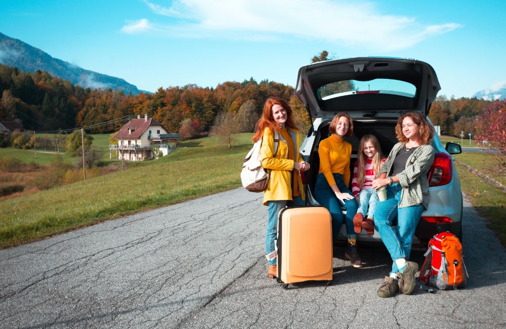 Military family traveling with luggage and car rentals