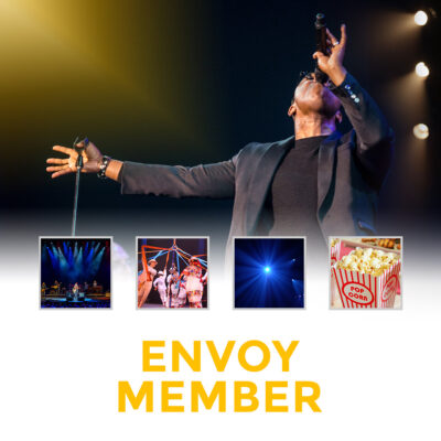 singer with microphone and the words "envoy member"
