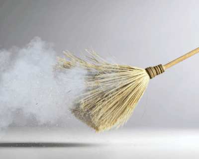 Broom sweeping floor in preparation for home cleanout
